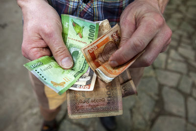 Close-up of man holding paper currency