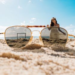 Woman on sand at beach against sky