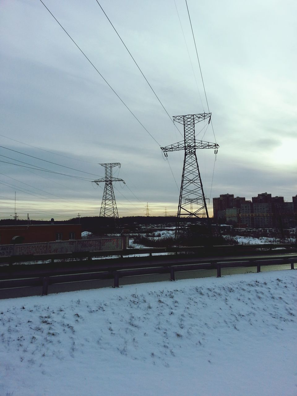 sky, power line, electricity pylon, connection, built structure, cloud - sky, cable, architecture, electricity, building exterior, snow, transportation, power supply, cloudy, winter, cloud, weather, cold temperature, outdoors, fuel and power generation