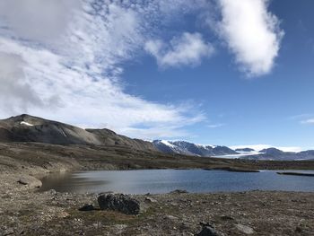 Scenic view of lake and mountains against sky