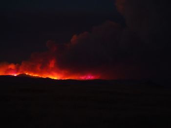 Scenic view of silhouette mountain against sky at night