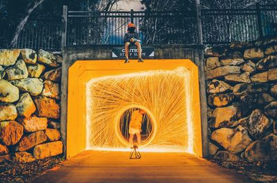 Man standing by wire wool in tunnel