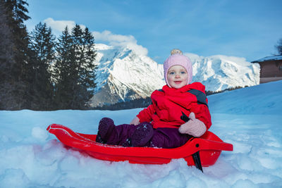 Portrait of woman sitting on snow