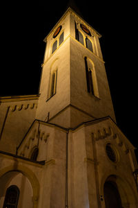 Low angle view of illuminated building against sky at night