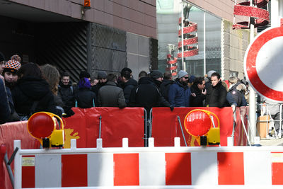 People standing in front of red building