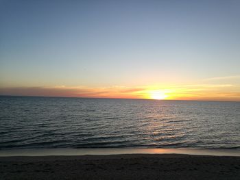 Scenic view of sea against clear sky during sunset