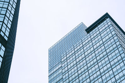 Low angle view of modern glass building against clear sky