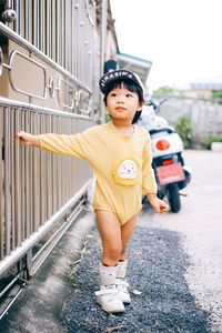 Portrait of young woman standing on street