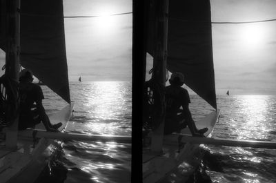 Men standing on boat in sea against sky