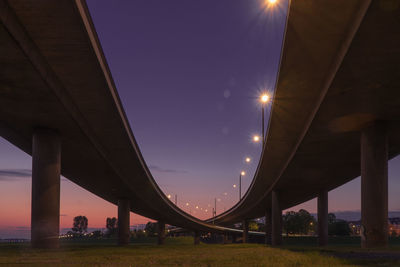 Low angle view of bridge against sky at night