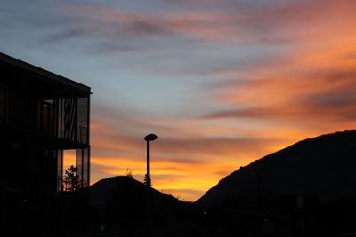 Low angle view of silhouette buildings against sky during sunset