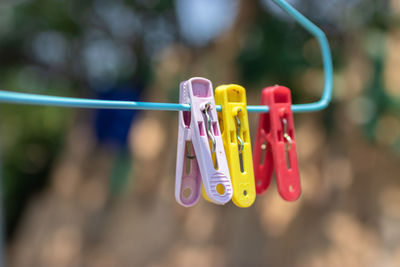 Close-up of clothespins hanging on clothesline