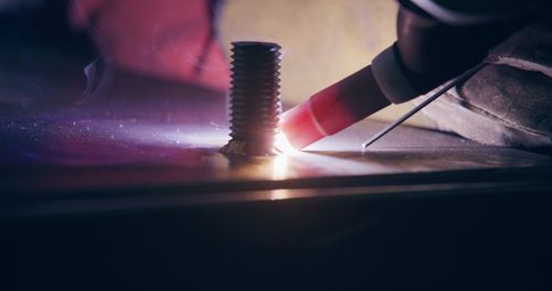 Cropped image of man standing on table