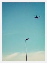 Low angle view of airplane flying in sky