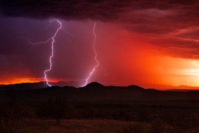 Lightning strikes from a monsoon thunderstorm at sunset over nogales, arizona.