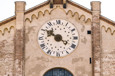 Low angle view of clock on wall