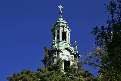 Low angle view of church against clear blue sky