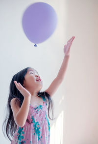 Girl playing with balloon