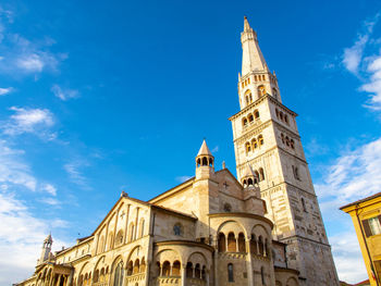 The ghirlandina the bell tower of modena italy and the wonderful romanic dome against the blue sky