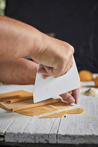 Cropped hand of man working on table