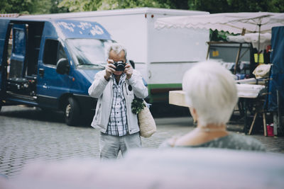 Rear view of people walking on street