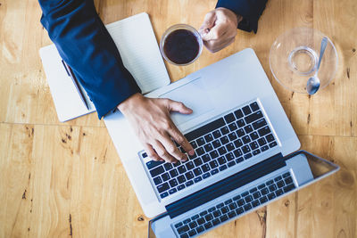 High angle view of man using laptop on table