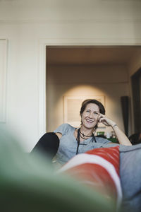 Portrait of a smiling young man sitting at home