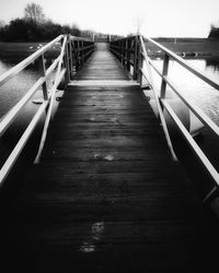 Empty wooden footbridge along footpath