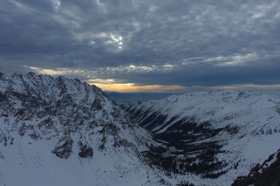 Scenic view of snowcapped mountains against sky during sunset