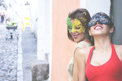 Portrait of two women wearing venice carnival mask. 