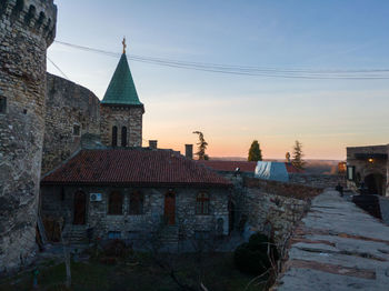 Old building in city against sky during sunset