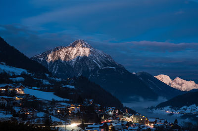 Aerial view of illuminated city against sky during winter