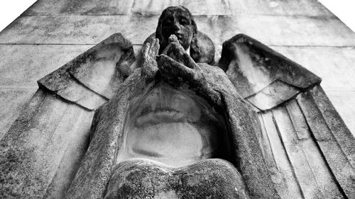 Low angle view of angel statue at temple