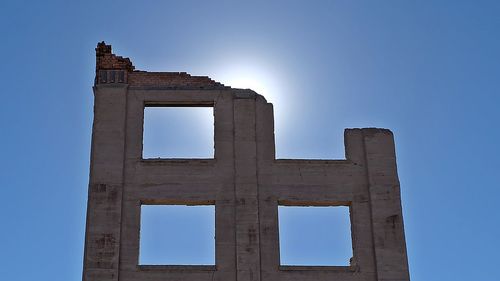 Low angle view of historical building against clear blue sky