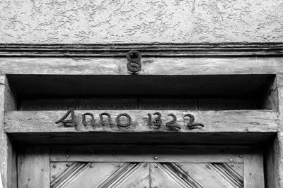 Low angle view of text on old door
