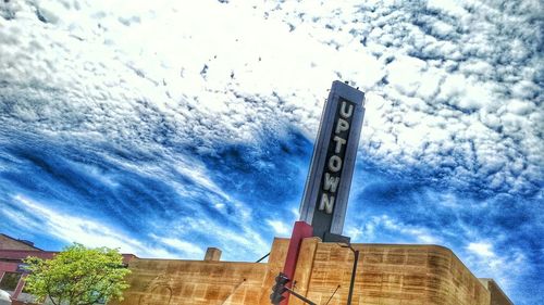 Low angle view of tower against cloudy sky