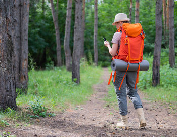 Full length of woman walking in forest