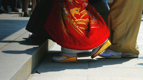 Low section of woman standing on tiled floor