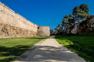 View of old ruins against clear blue sky