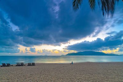 Scenic view of beach against sky during sunset