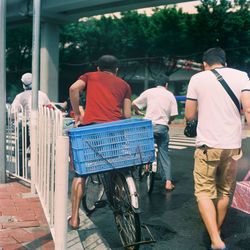 Rear view of men on street