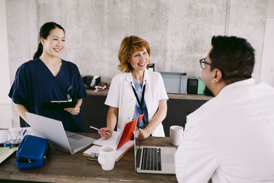 Smiling multiracial medical team discussing at hospital