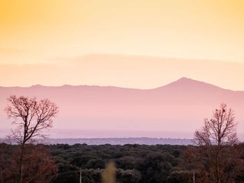 Scenic view of mountains against sky at sunset