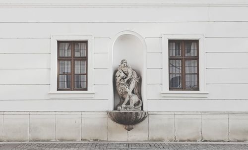 Statue against building