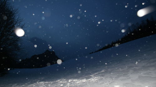 Close-up of snowflakes on water at night