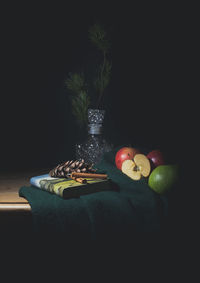 Close-up of apple on table against black background