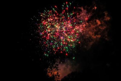 Low angle view of firework display at night