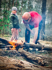 Full length of a man on wooden table in forest