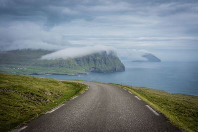 Road by sea against sky