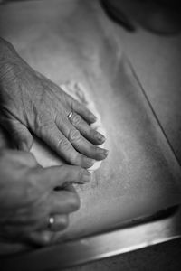 Cropped hands of woman preparing food at home